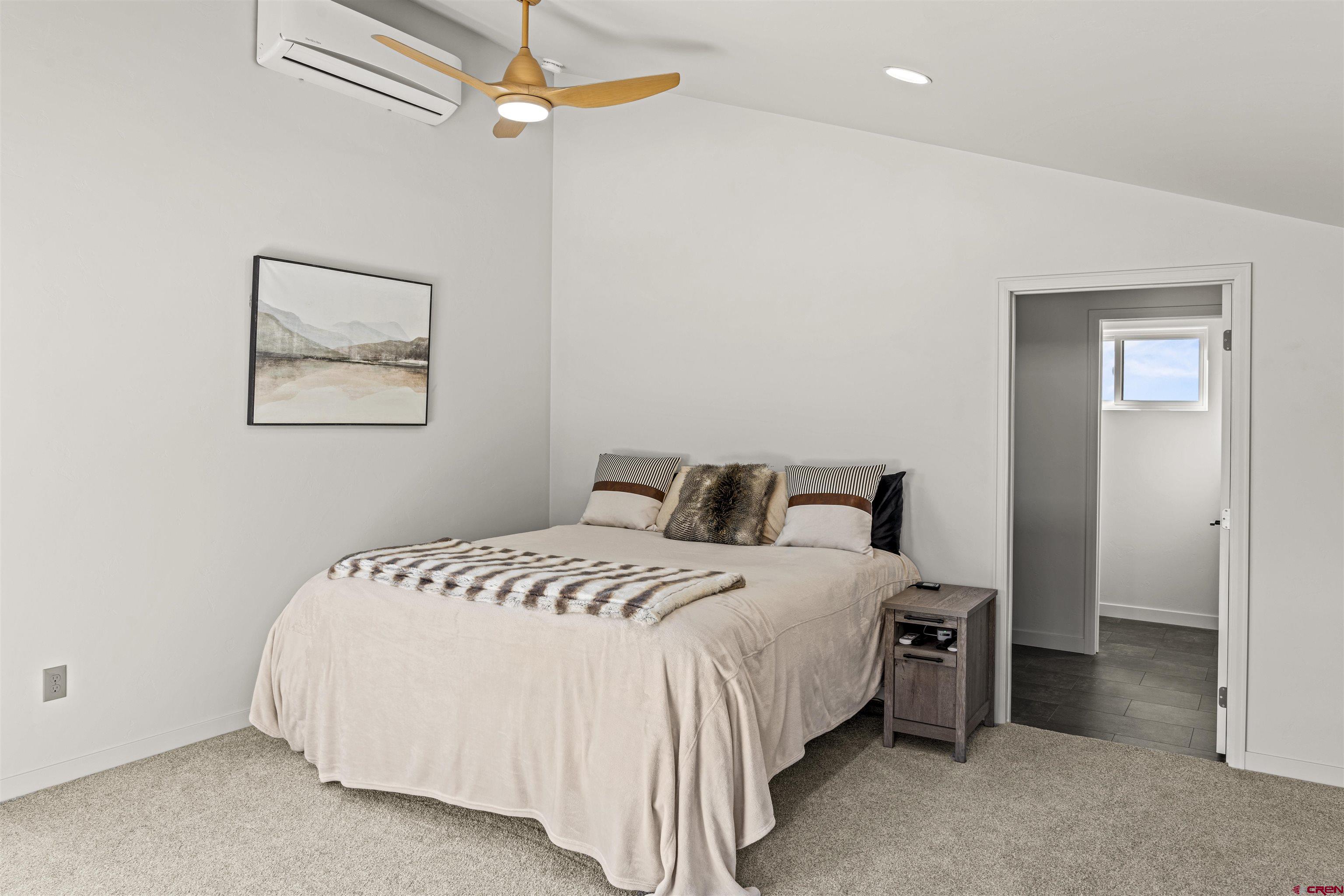 70848 Buckhorn Road Montrose, CO 81403 - Photo 31 of 43 a bedroom with bed and a chandelier