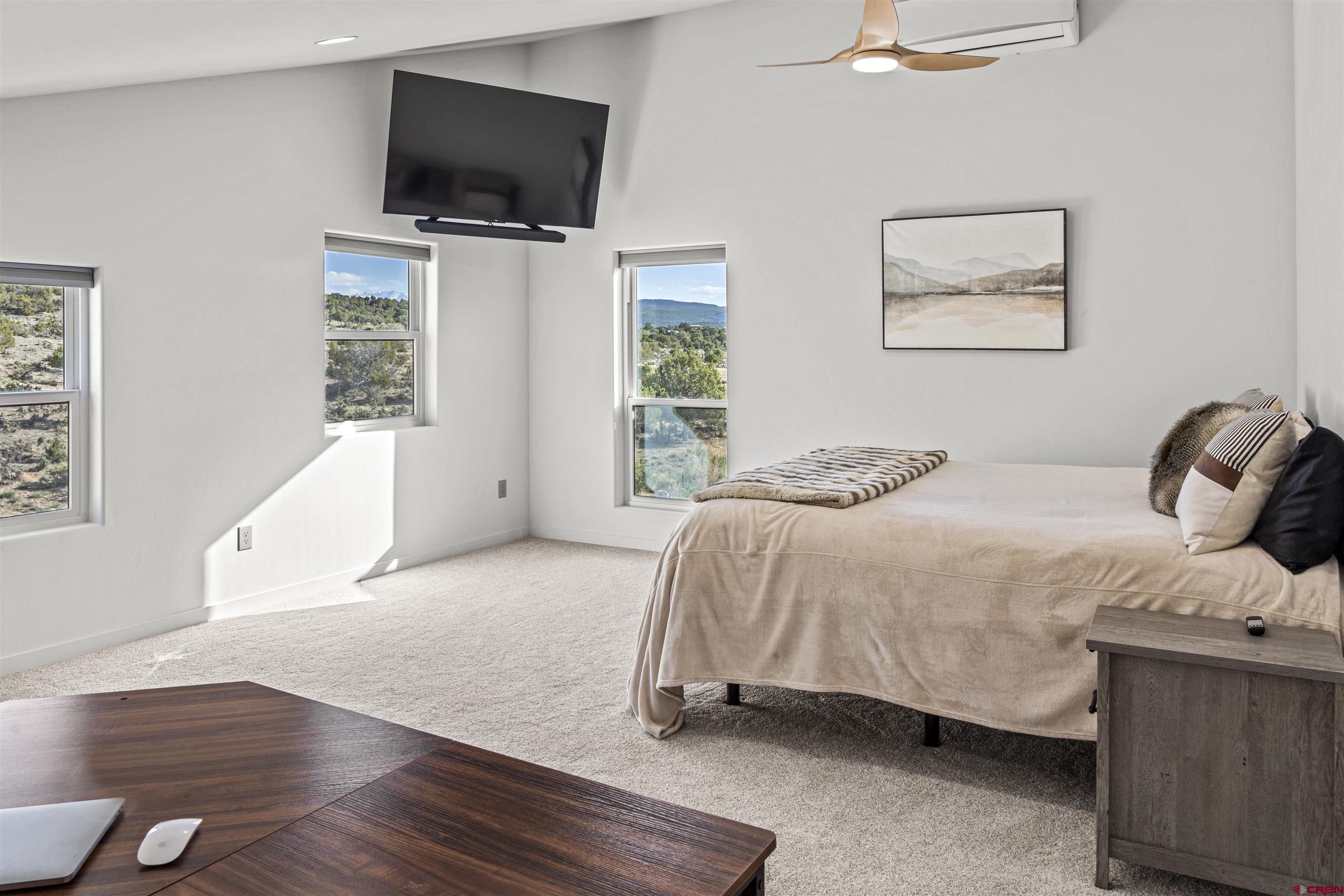 70848 Buckhorn Road Montrose, CO 81403 - Photo 33 of 43 a bedroom with a bed and a flat screen tv