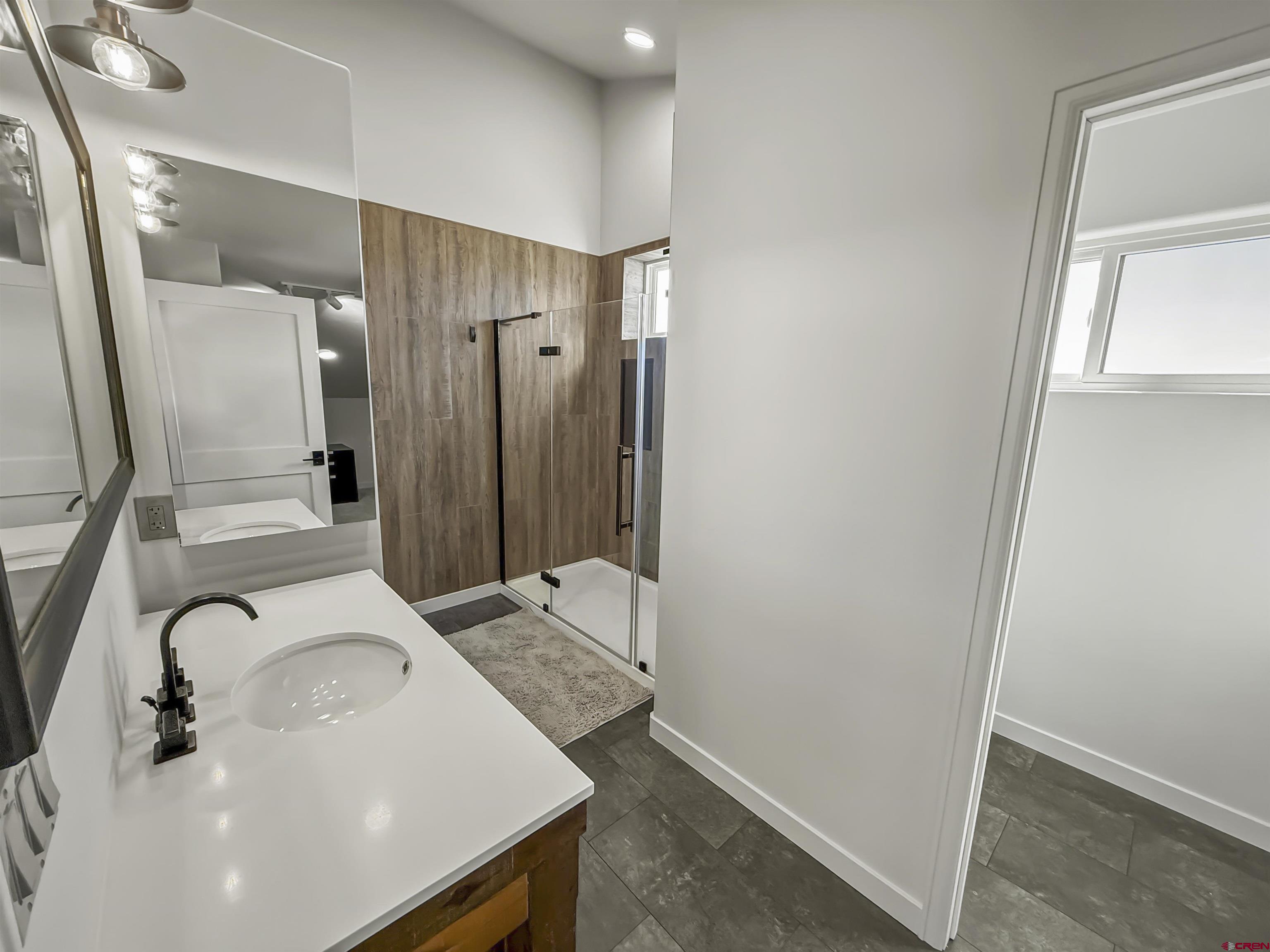 70848 Buckhorn Road Montrose, CO 81403 - Photo 35 of 43 a bathroom with a sink and a mirror
