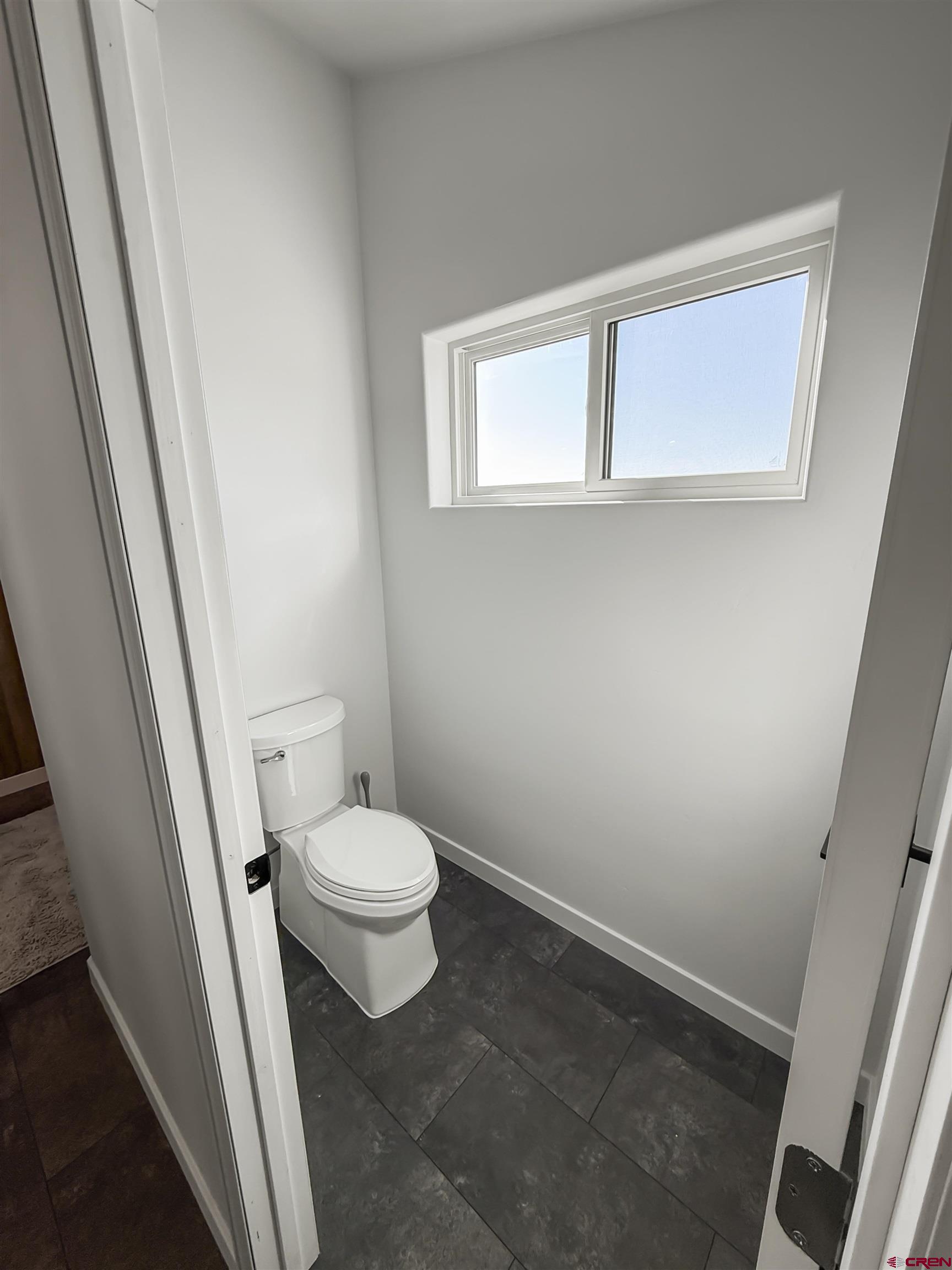 70848 Buckhorn Road Montrose, CO 81403 - Photo 36 of 43 a white toilet sitting in a bathroom next to a sink