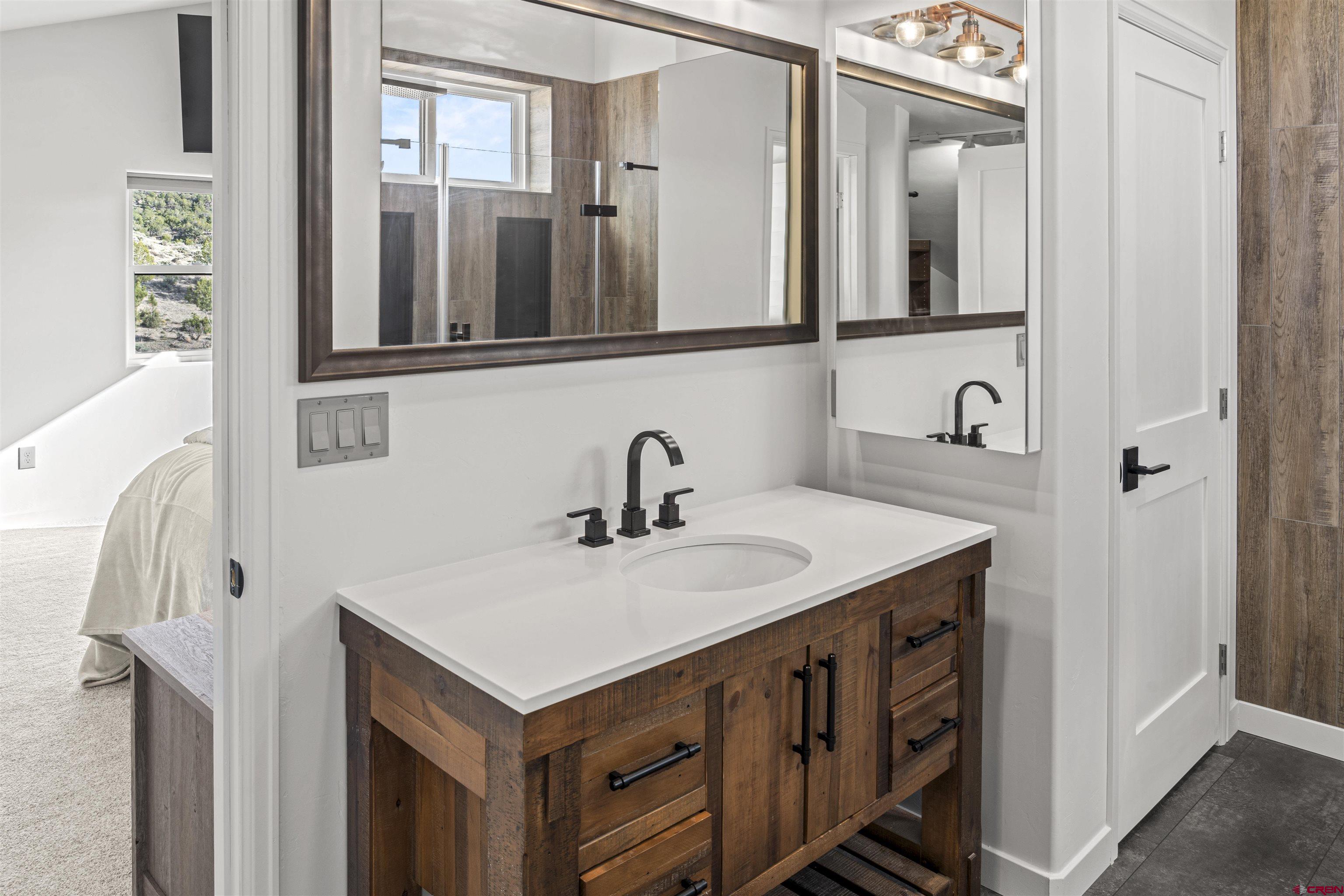 70848 Buckhorn Road Montrose, CO 81403 - Photo 37 of 43 a bathroom with a sink and a mirror
