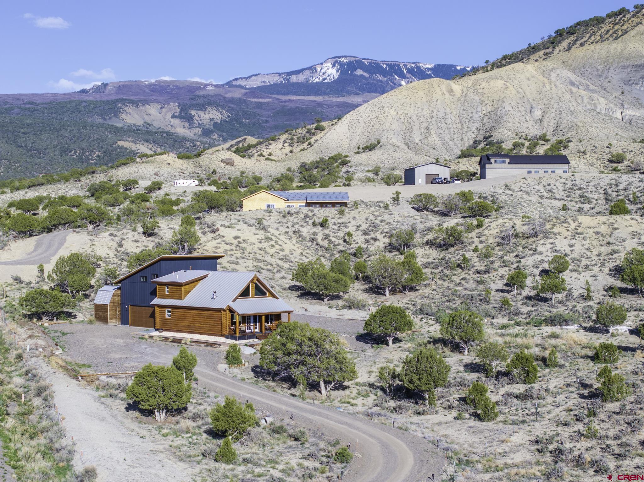 70848 Buckhorn Road Montrose, CO 81403 - Photo 4 of 43 an aerial view of a house with a mountain