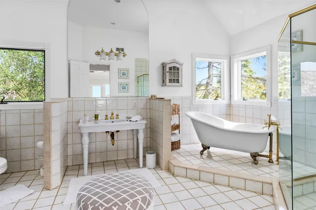 a spacious bathroom with a bathtub and a sink