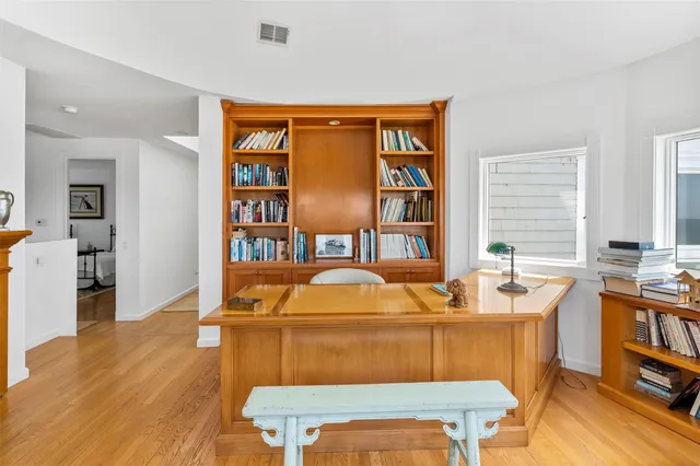 a living room with furniture a rug and a bookshelf