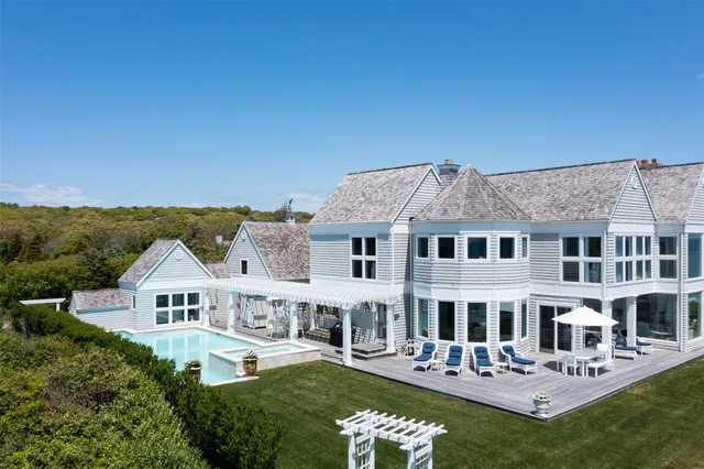 a aerial view of a house with a big yard and potted plants