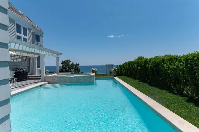 a view of a patio with swimming pool table and chairs