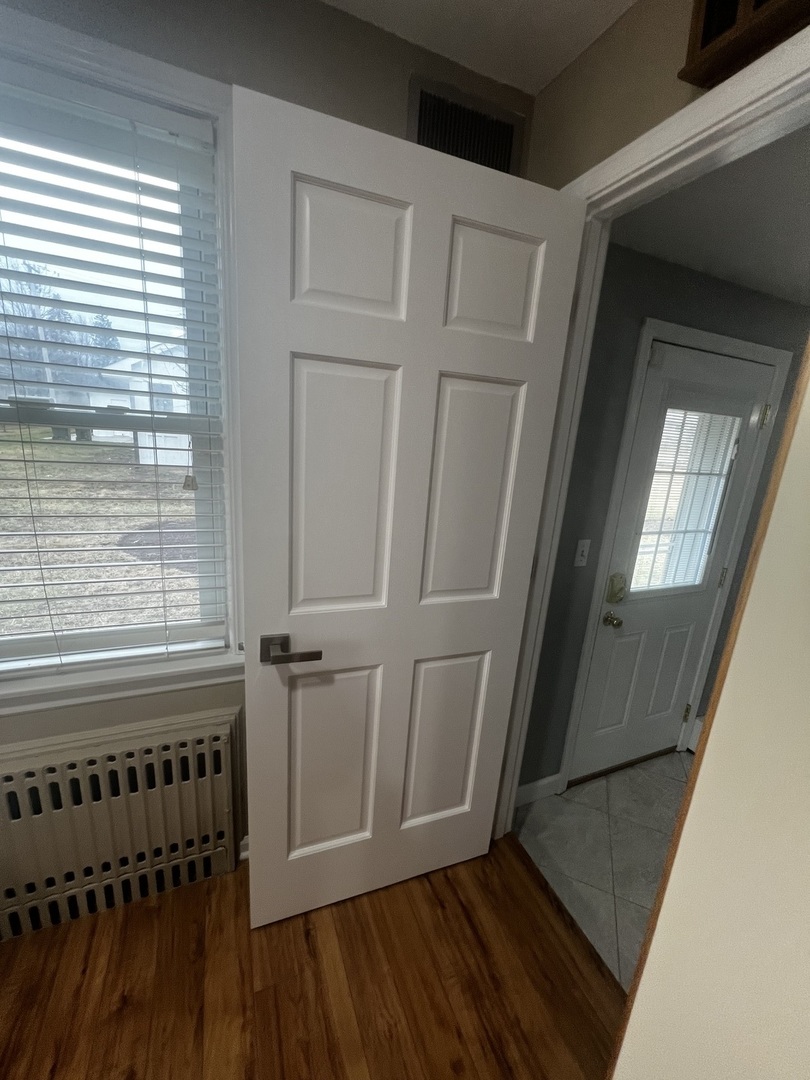 1615 Greenwood Road Glenview, IL 60026 - Photo 15 of 41 a view of a hallway with wooden floor and staircase