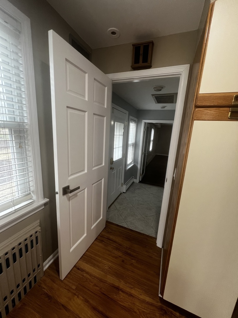 1615 Greenwood Road Glenview, IL 60026 - Photo 19 of 41 a view of a hallway with wooden floor and staircase