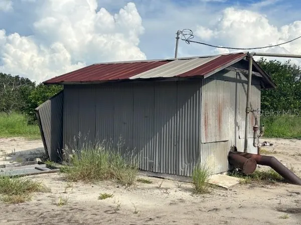 a backyard of a house with yard and outdoor seating