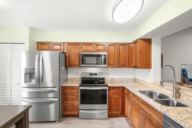 a kitchen with stainless steel appliances a refrigerator stove and microwave
