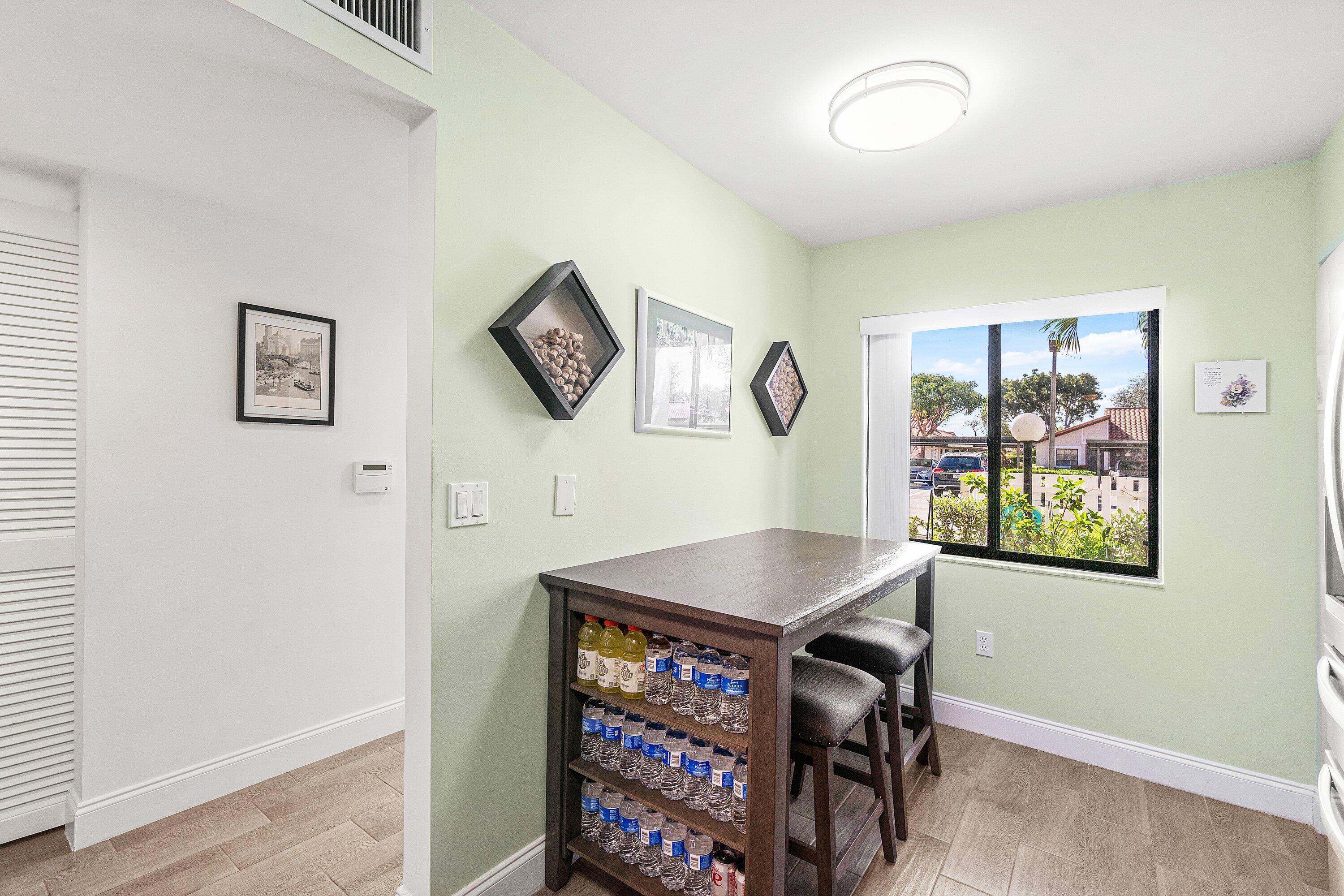 6149 Pointe Regal Circle, Unit 108 Delray Beach, FL 33484 - Photo 14 of 56 a view of a workspace with furniture and a window