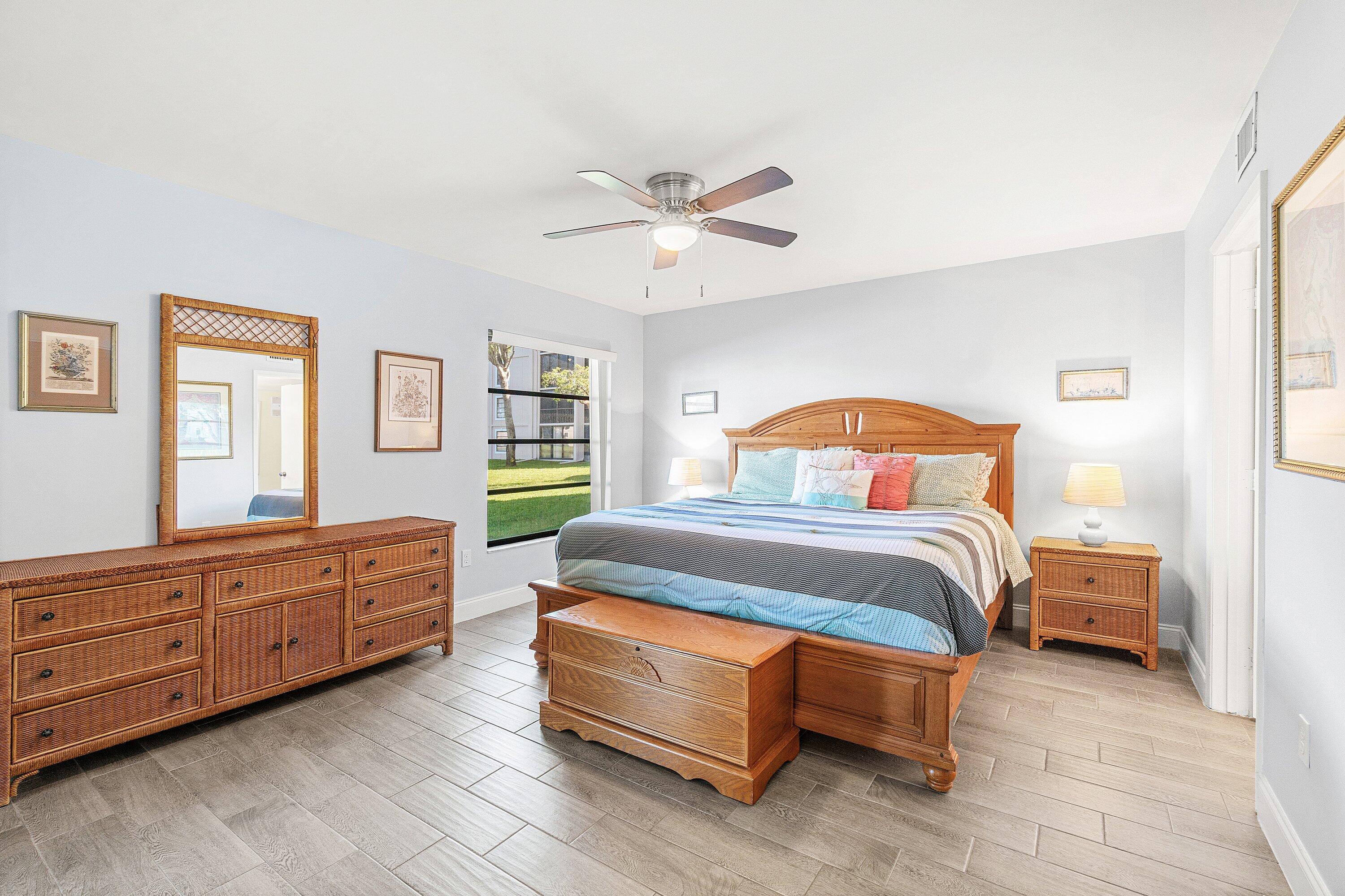 6149 Pointe Regal Circle, Unit 108 Delray Beach, FL 33484 - Photo 18 of 56 a bedroom with a bed and window