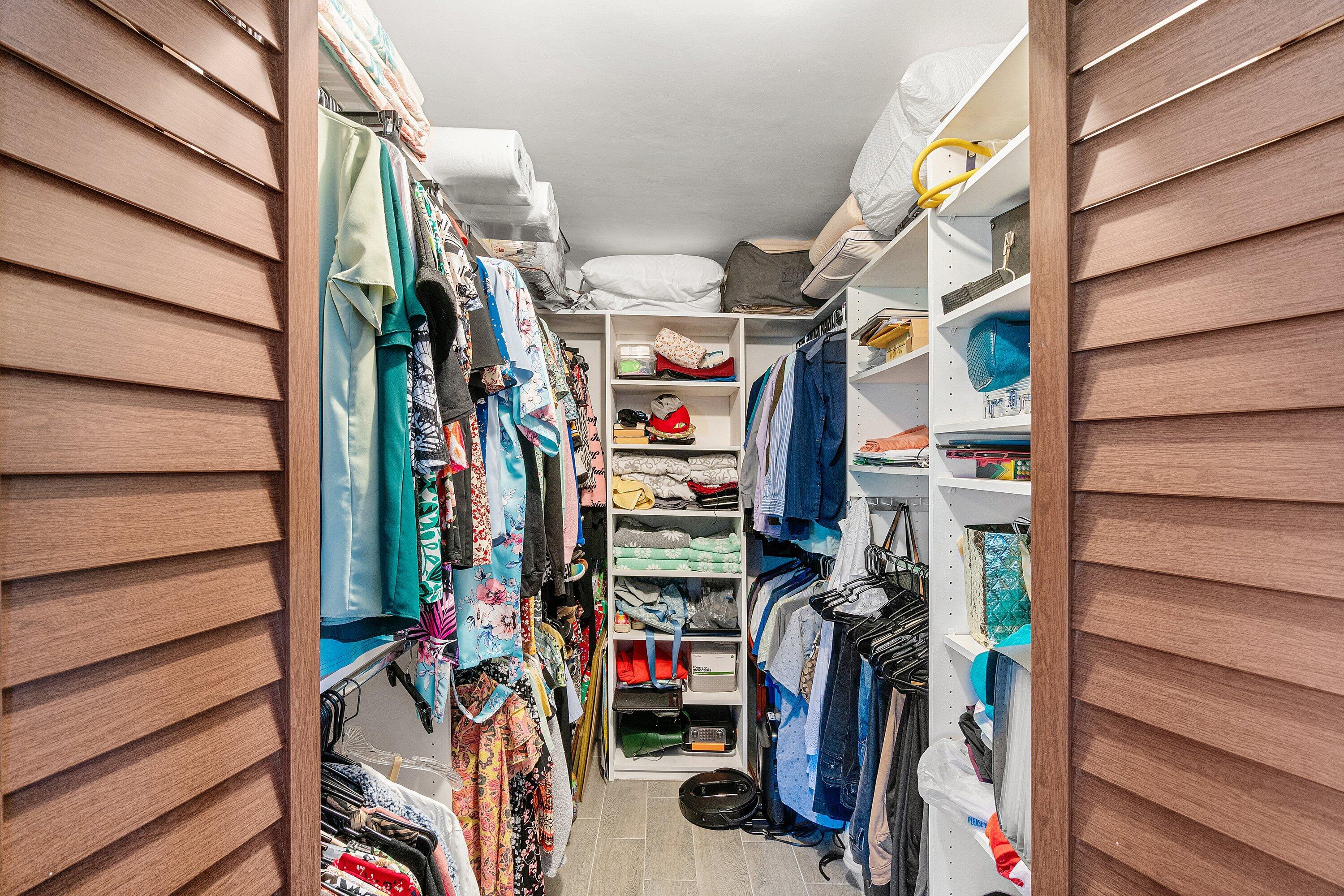 6149 Pointe Regal Circle, Unit 108 Delray Beach, FL 33484 - Photo 23 of 56 a view of walk in closet with clothes