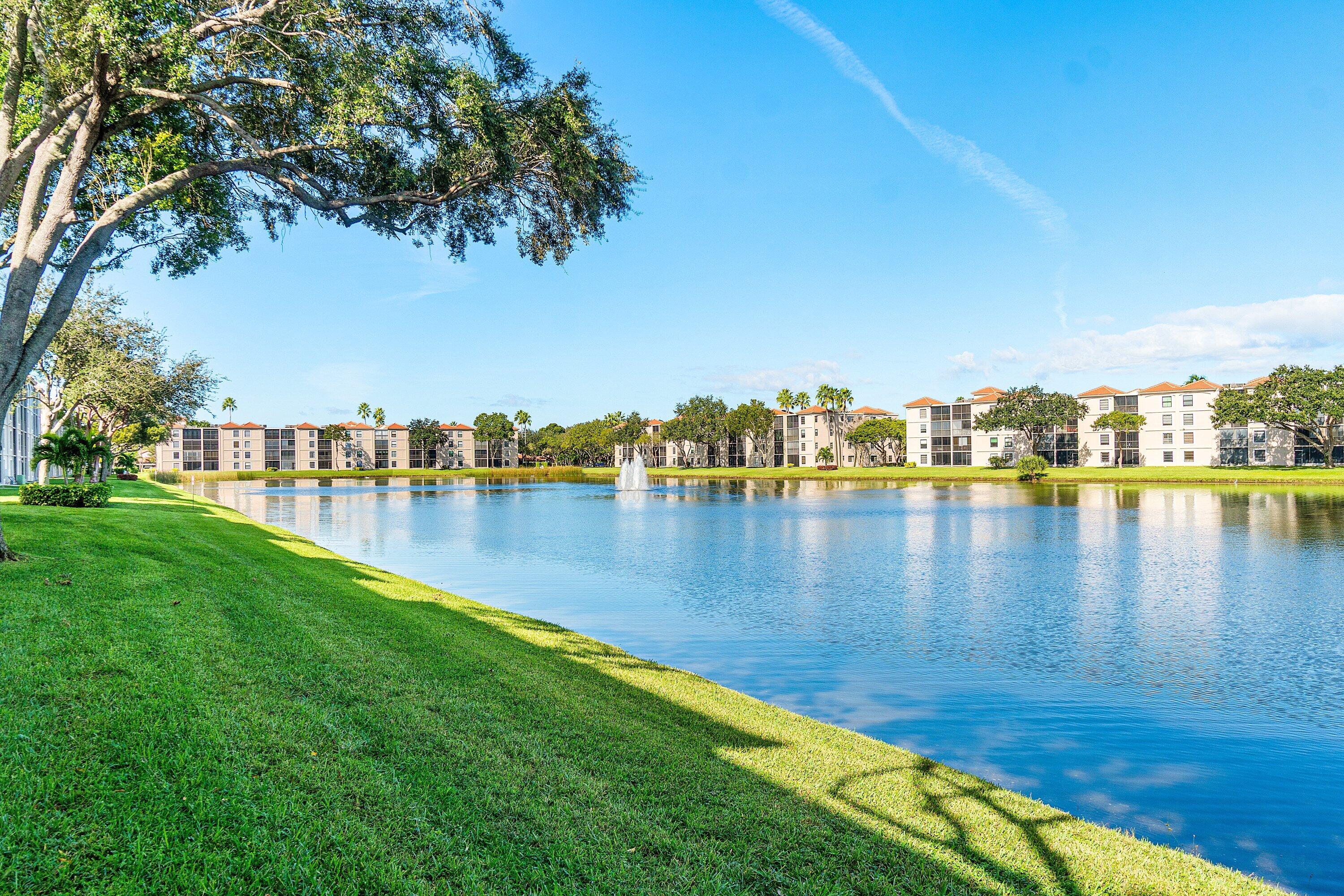6149 Pointe Regal Circle, Unit 108 Delray Beach, FL 33484 - Photo 30 of 56 a view of a lake with houses