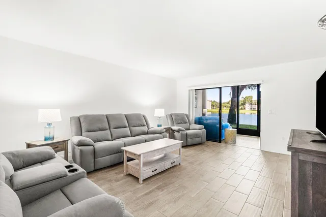 a kitchen with stainless steel appliances granite countertop a sink stove microwave and refrigerator