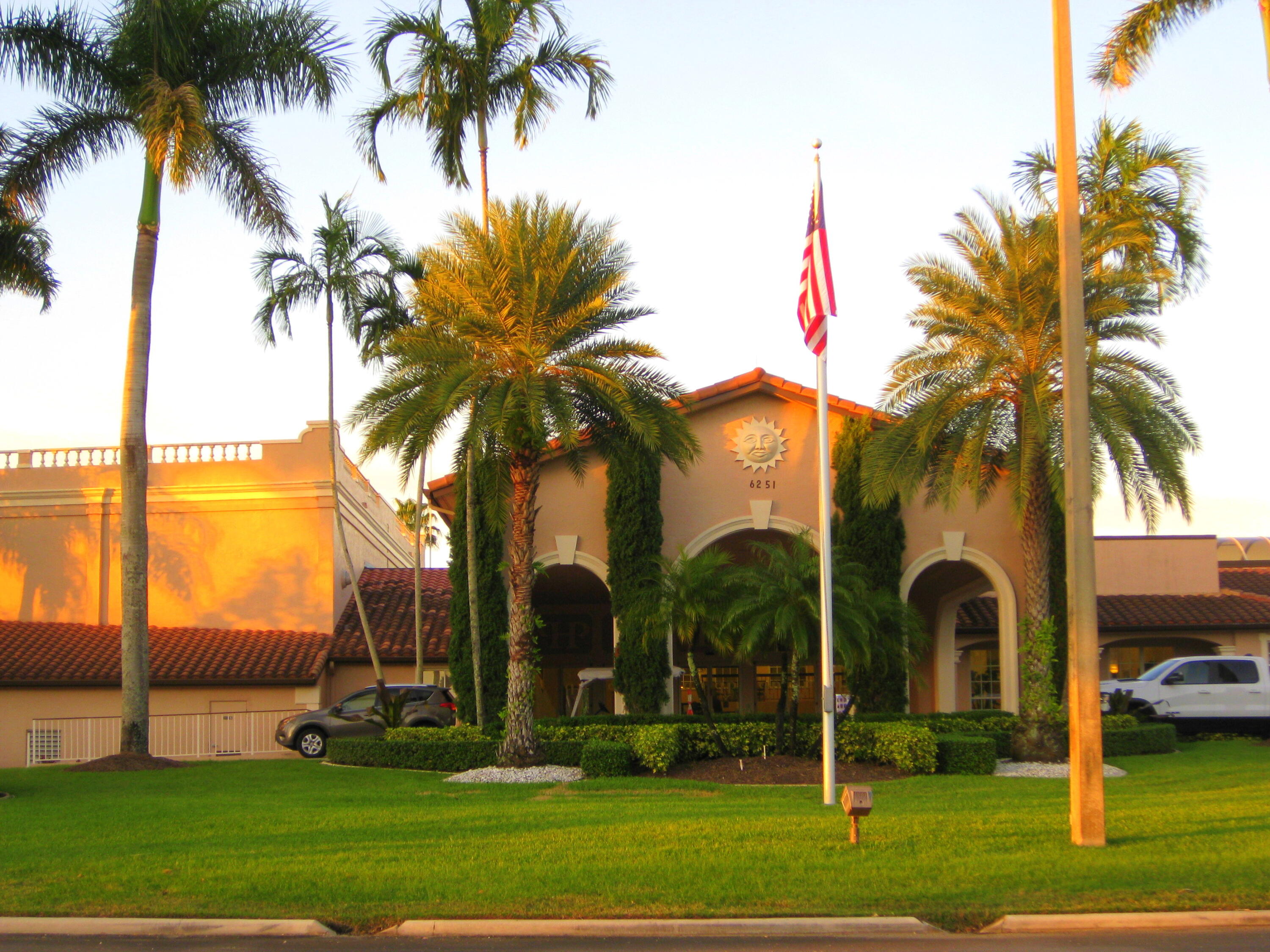 6149 Pointe Regal Circle, Unit 108 Delray Beach, FL 33484 - Photo 55 of 56 a front view of multi story residential apartment building with yard and green space