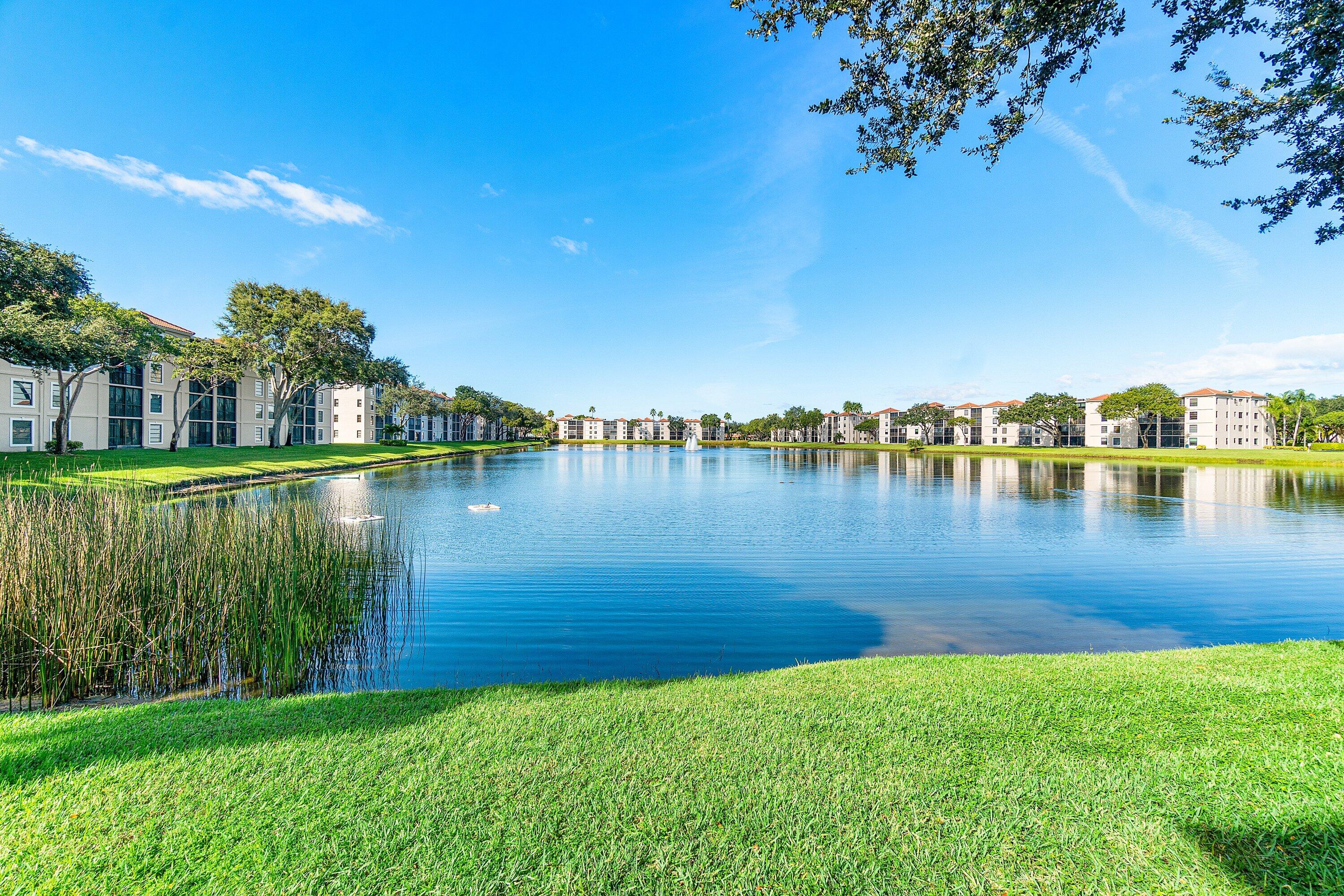 6149 Pointe Regal Circle, Unit 108 Delray Beach, FL 33484 - Photo 8 of 56 a view of a lake with houses in the back
