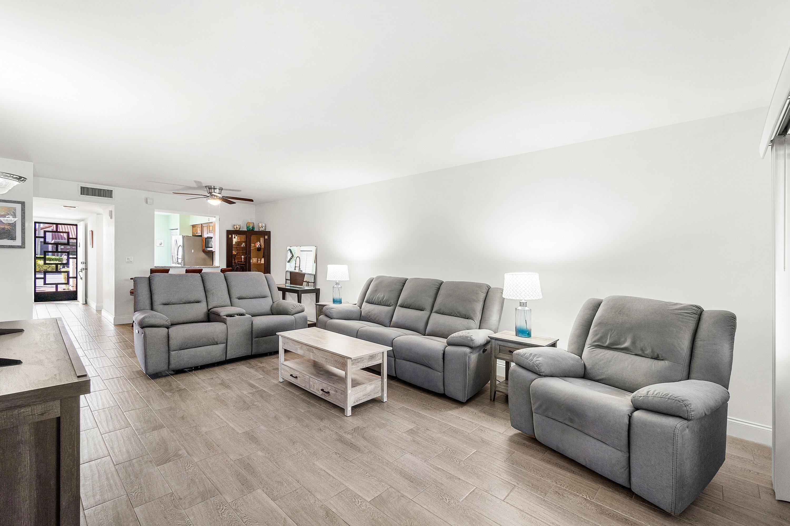 6149 Pointe Regal Circle, Unit 108 Delray Beach, FL 33484 - Photo 9 of 56 a living room with furniture and white walls