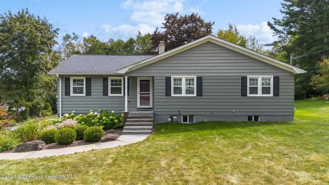 a view of a house with a yard and plants