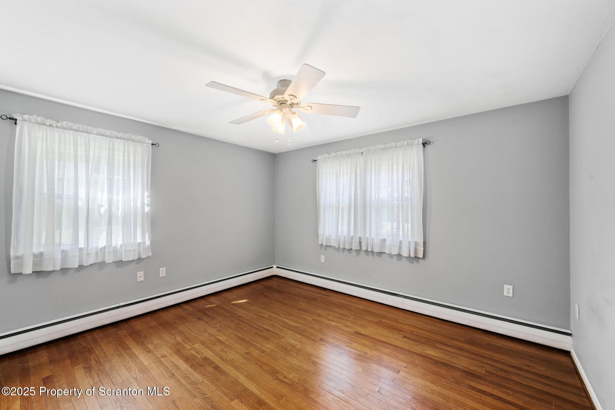 525 Knapp Road Clarks Summit, PA 18411 - Photo 15 of 45 a view of empty room with wooden floor and fan