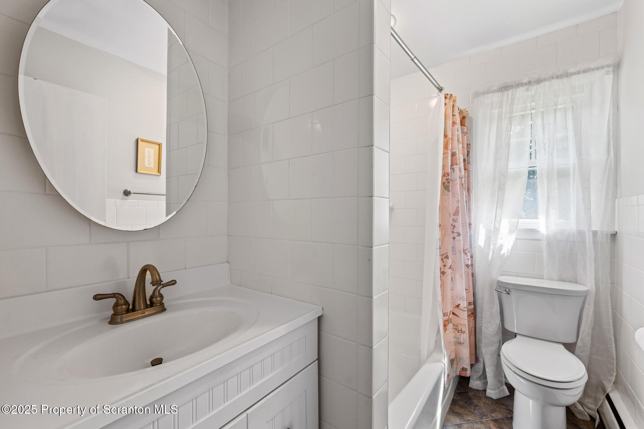 525 Knapp Road Clarks Summit, PA 18411 - Photo 19 of 45 a bathroom with a sink a toilet and a mirror