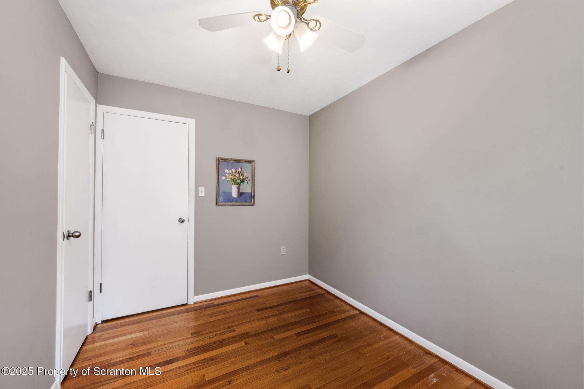 525 Knapp Road Clarks Summit, PA 18411 - Photo 21 of 45 a view of empty room with wooden floor and fan