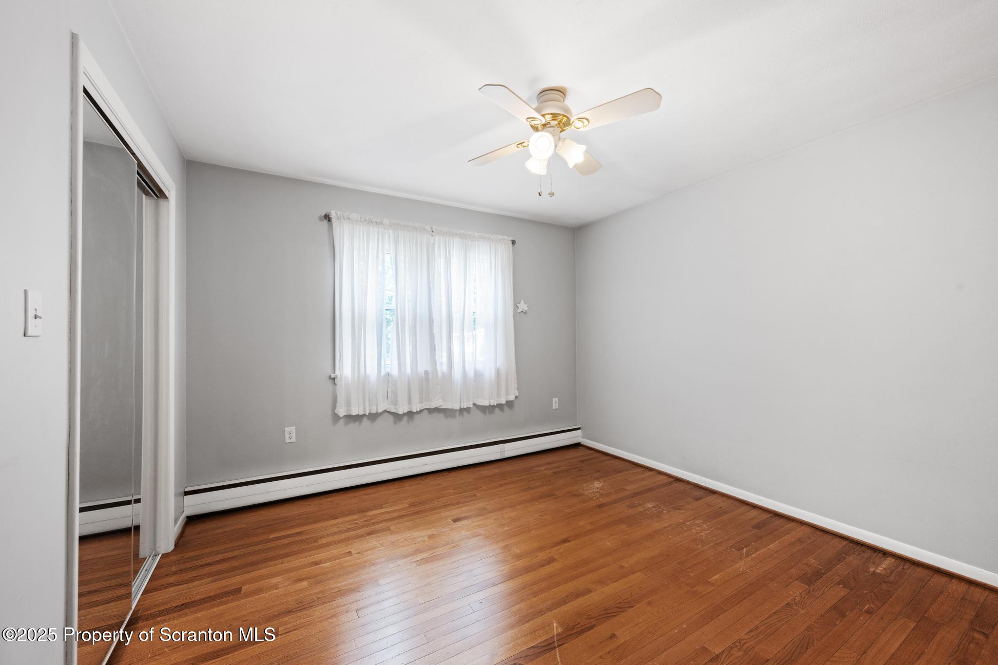 525 Knapp Road Clarks Summit, PA 18411 - Photo 23 of 45 an empty room with wooden floor and fan