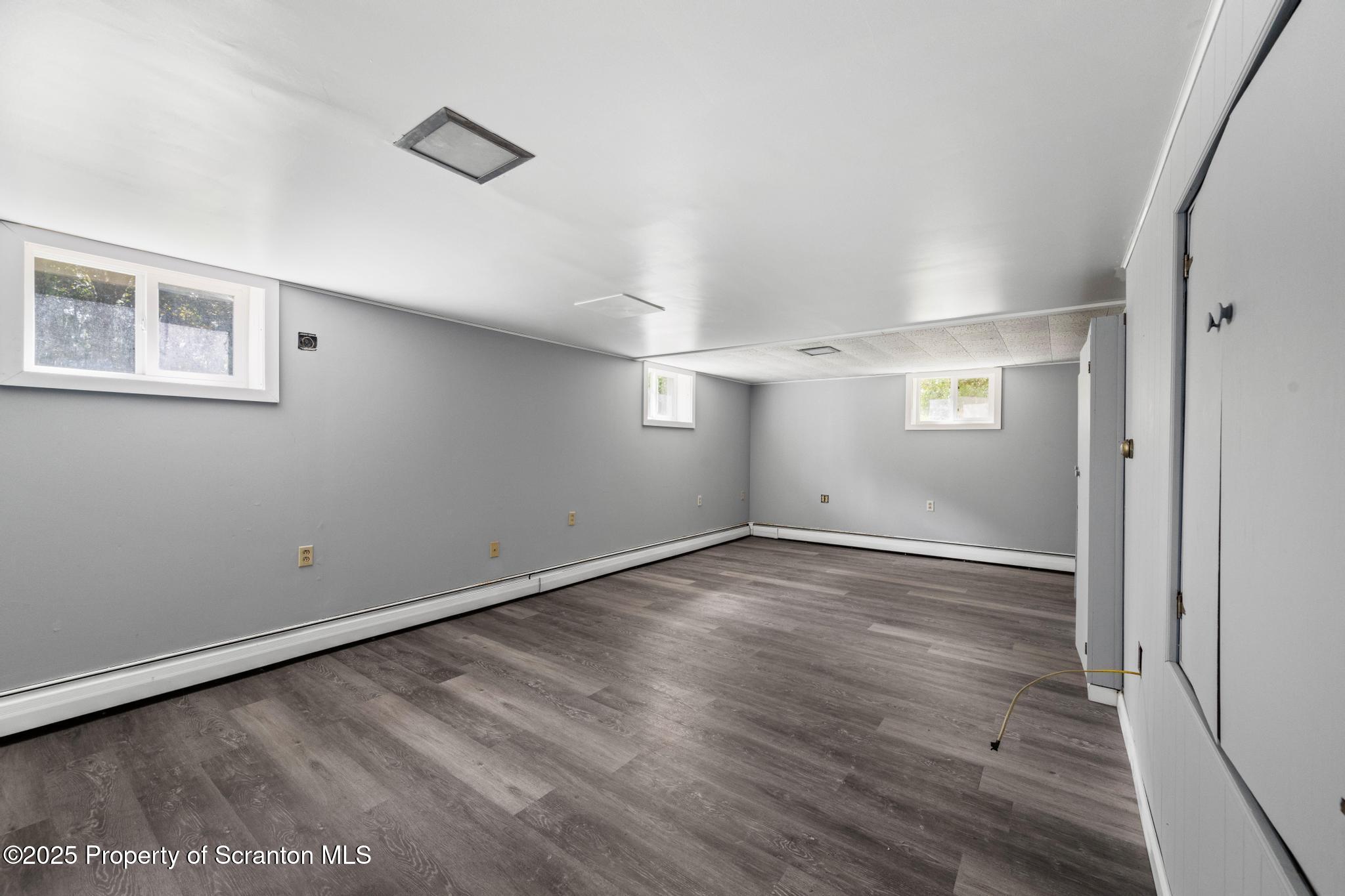 525 Knapp Road Clarks Summit, PA 18411 - Photo 27 of 45 an empty room with wooden floor and windows