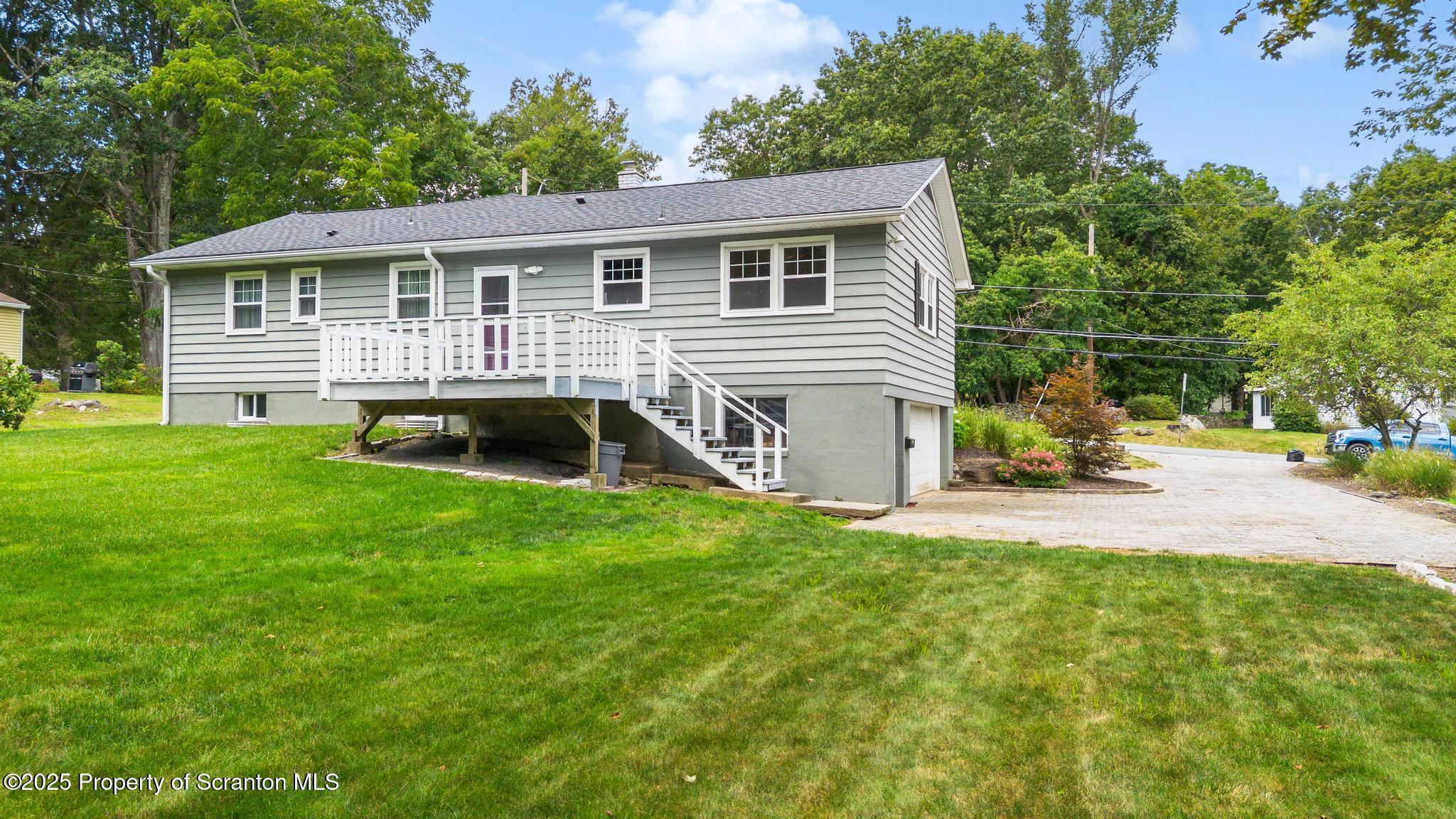 525 Knapp Road Clarks Summit, PA 18411 - Photo 39 of 45 a view of a house with a backyard and a patio