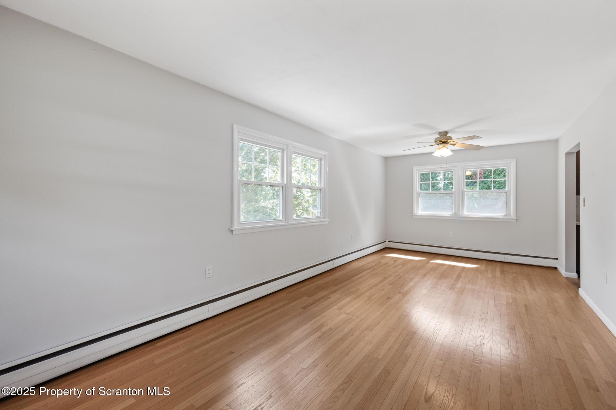 525 Knapp Road Clarks Summit, PA 18411 - Photo 4 of 45 an empty room with wooden floor and windows