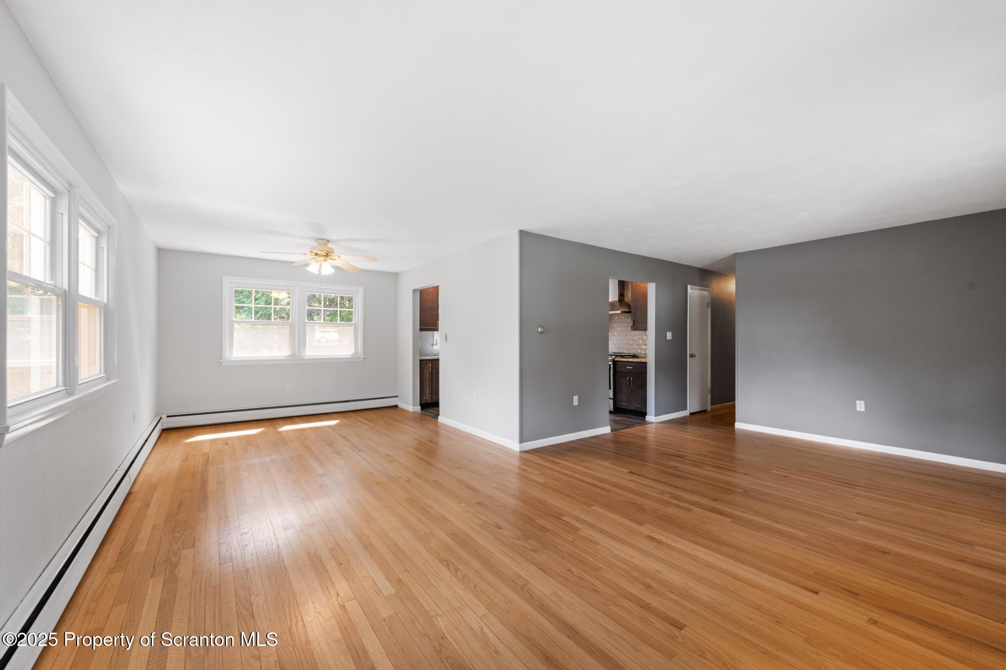 525 Knapp Road Clarks Summit, PA 18411 - Photo 5 of 45 an empty room with wooden floor and windows