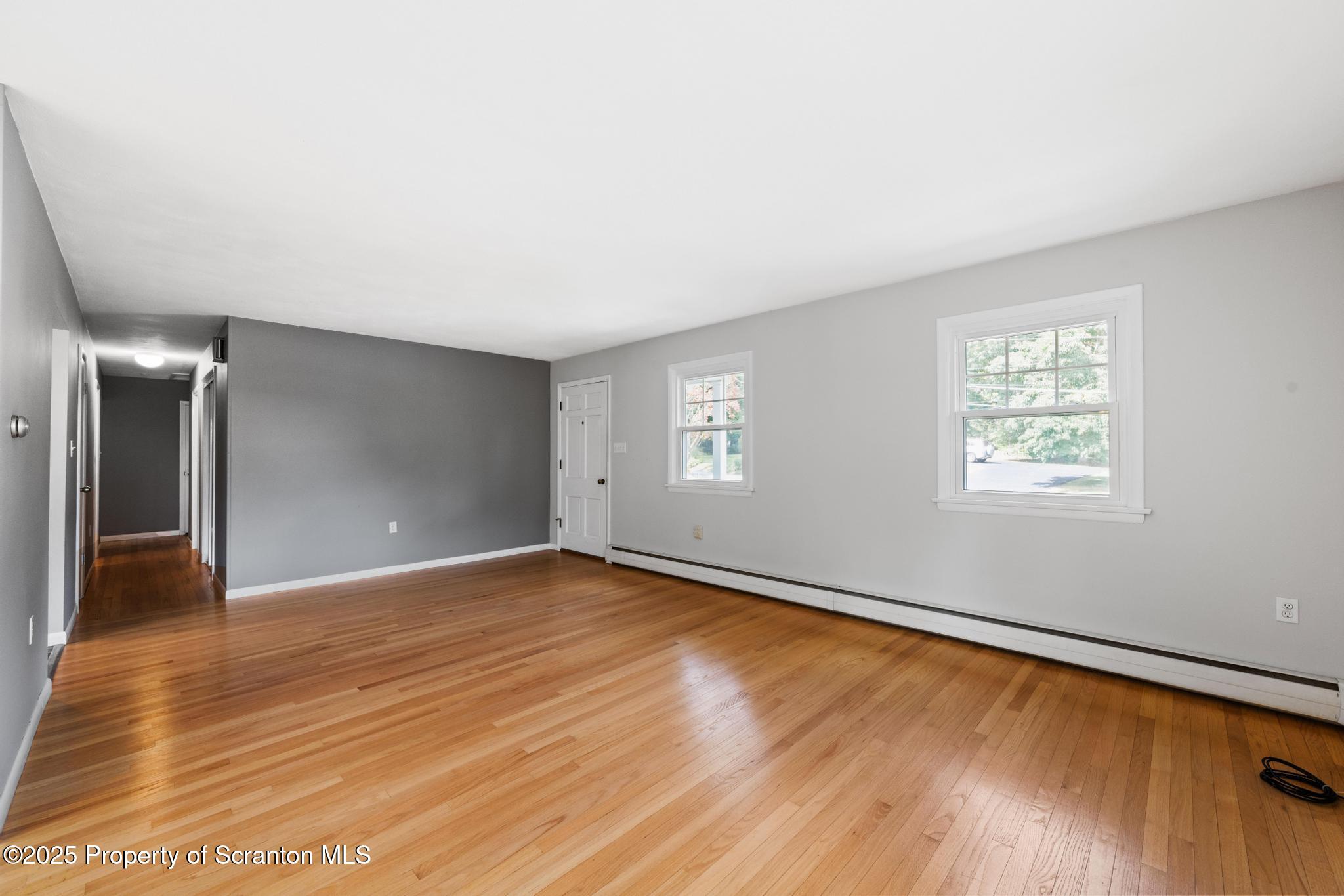 525 Knapp Road Clarks Summit, PA 18411 - Photo 7 of 45 an empty room with wooden floor and windows