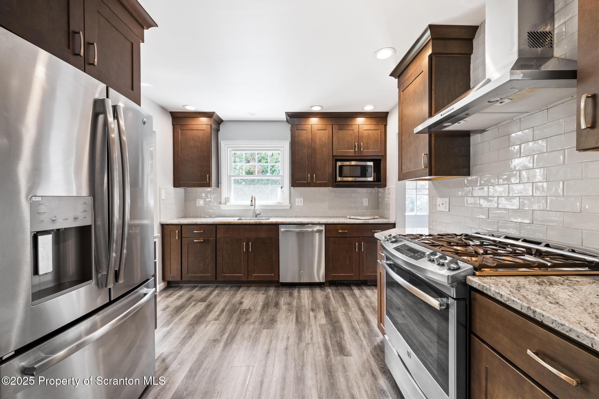 525 Knapp Road Clarks Summit, PA 18411 - Photo 9 of 45 a kitchen with stainless steel appliances granite countertop a stove a sink and a refrigerator
