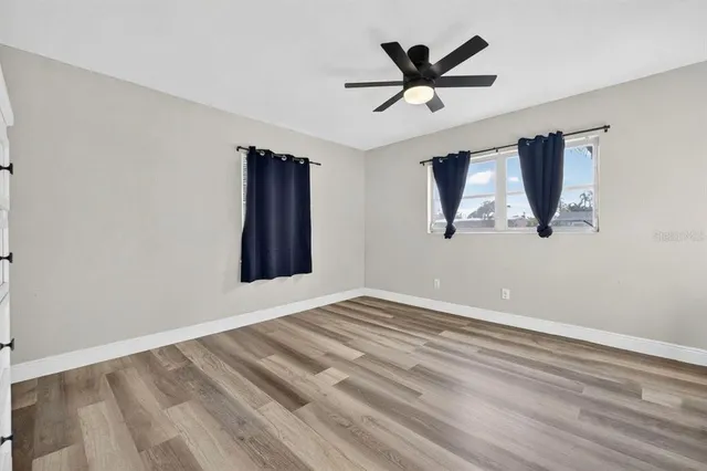 a view of room with window and ceiling fan