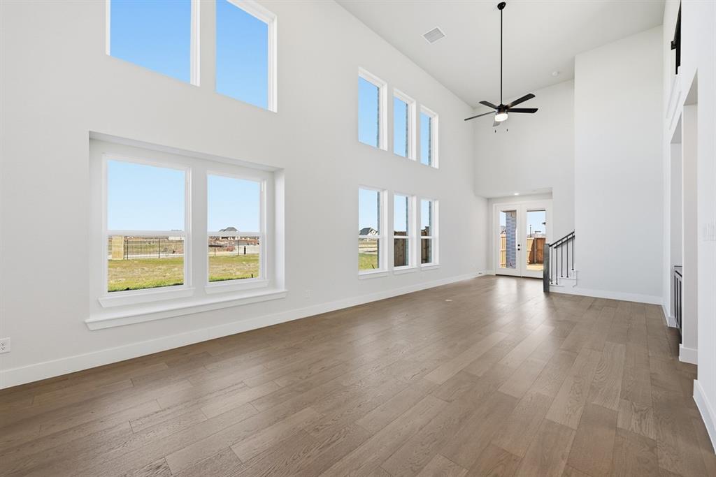 4408 Daisy Lane Prosper, TX 75078 - Photo 11 of 25 a view of empty room with wooden floor and fan