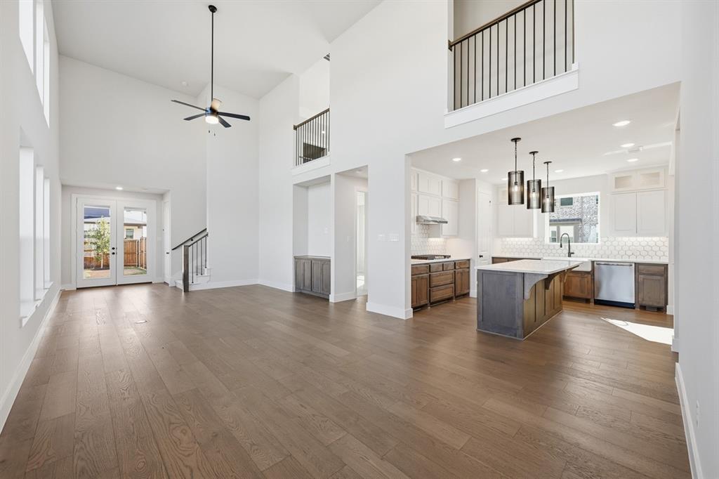 4408 Daisy Lane Prosper, TX 75078 - Photo 19 of 25 a view of a kitchen with a sink a refrigerator and a stove top oven