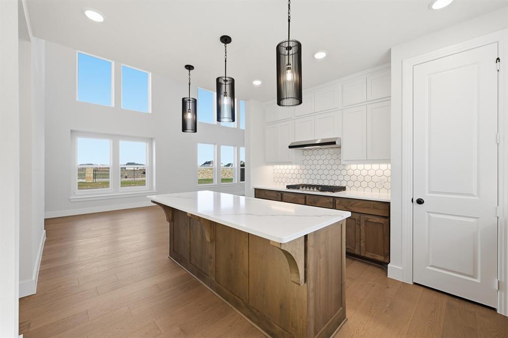 4408 Daisy Lane Prosper, TX 75078 - Photo 3 of 25 a kitchen with stainless steel appliances granite countertop a sink stove and refrigerator