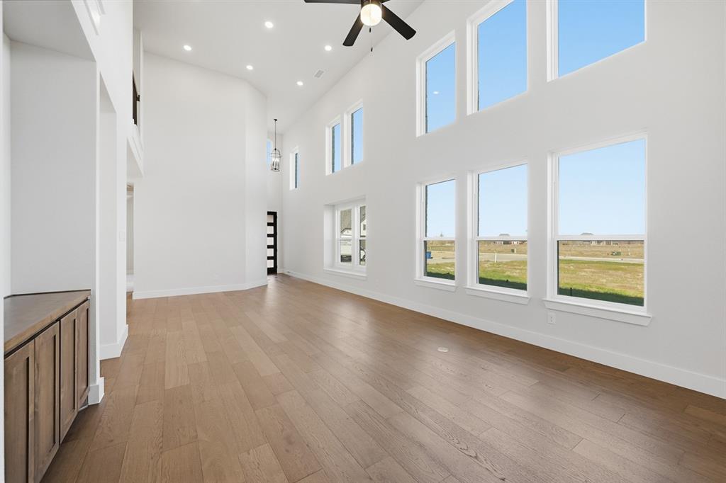 4408 Daisy Lane Prosper, TX 75078 - Photo 8 of 25 a view of an empty room with a window and wooden floor