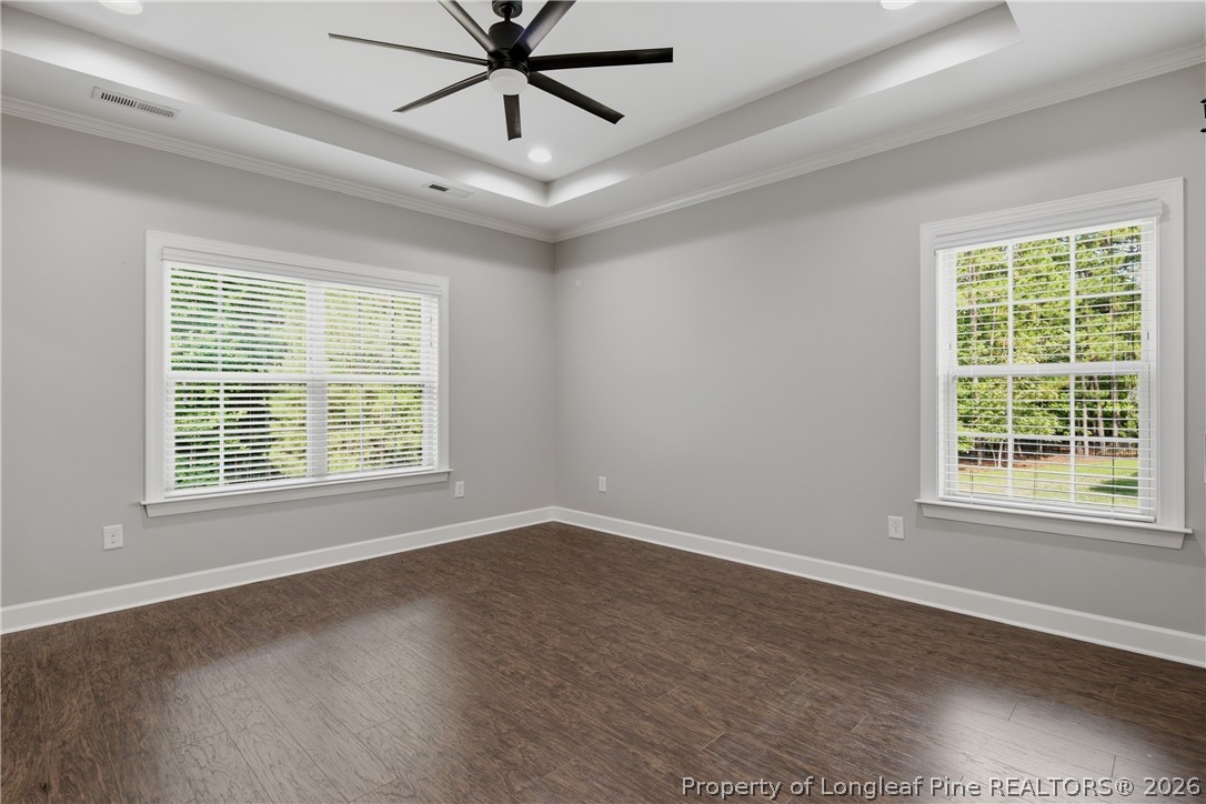 148 Heatherspring Way Spring Lake, NC 28390 - Photo 24 of 50 a view of an empty room with wooden floor and a window