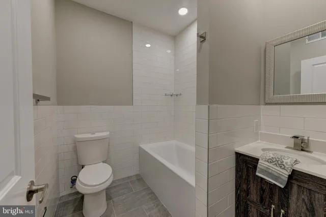 a bathroom with a sink a toilet and bathtub