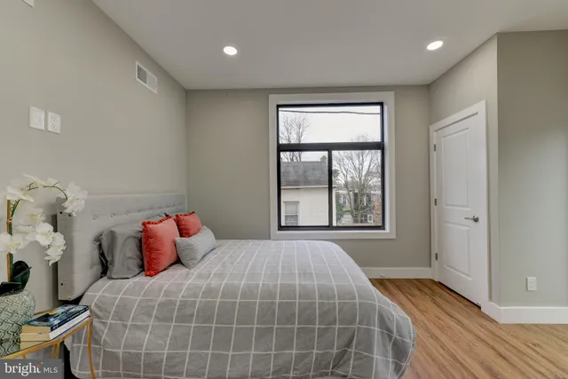 a bedroom with a bed and a window