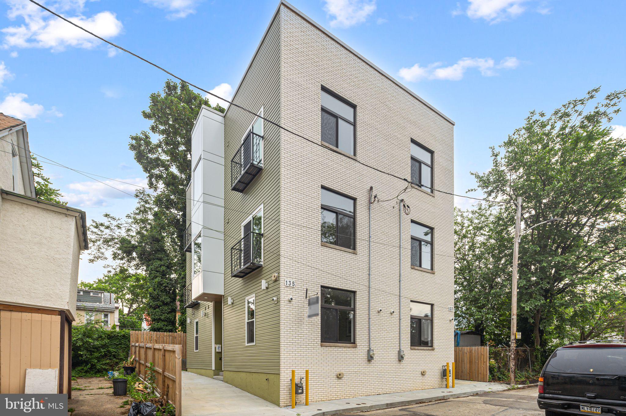135 East Springer Street Philadelphia, PA 19119 - Photo 2 of 32 a view of a white apartments with large tree