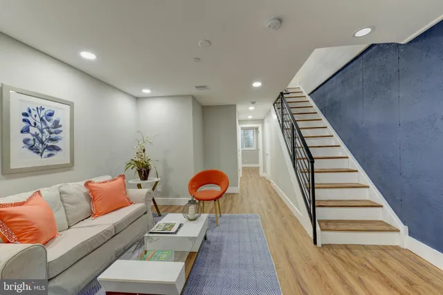 a living room with furniture and wooden floor