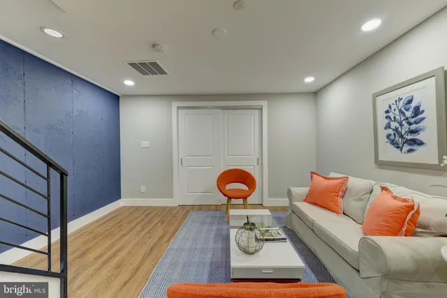 a living room with furniture and wooden floor