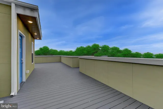 a view of a balcony with wooden floor and fence