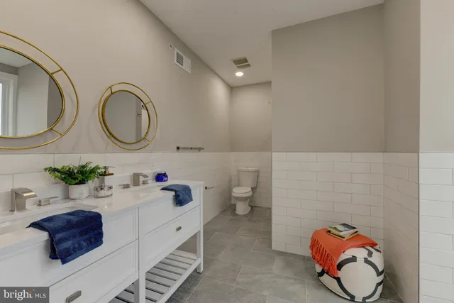 a bathroom with a sink mirror and vanity