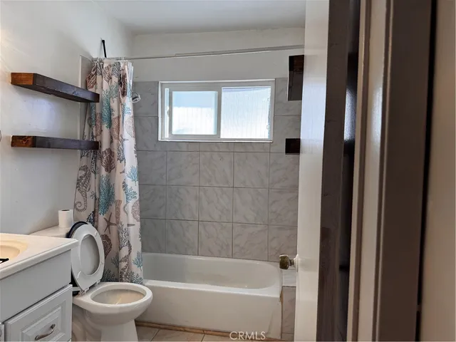 a bathroom with a toilet a sink and bathtub