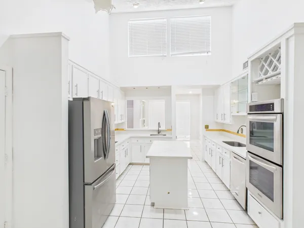 a kitchen with stainless steel appliances a refrigerator sink and cabinets