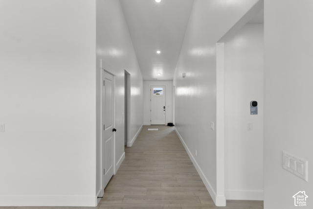 205 East 690th Street North Logan, UT 84321 - Photo 36 of 52 Hallway featuring recessed lighting, wood-finish flooring, white doors with black hardware, and a modern thermostat