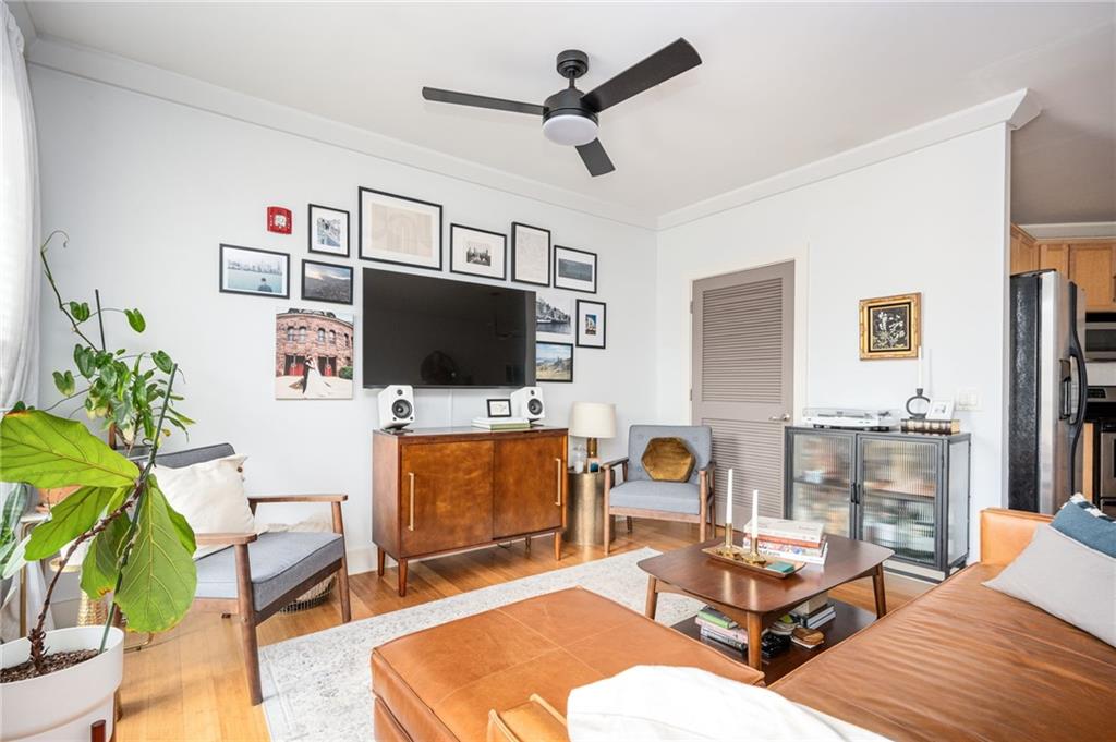 1628 Briarcliff Road Northeast, Unit 9 Atlanta, GA 30306 - Photo 12 of 25 a living room with furniture and a flat screen tv